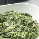 A creamy bowl of Easy Creamed Spinach, made with fresh spinach, garlic, cream cheese, and Parmesan, ready to serve.