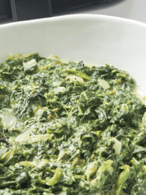 A creamy bowl of Easy Creamed Spinach, made with fresh spinach, garlic, cream cheese, and Parmesan, ready to serve.