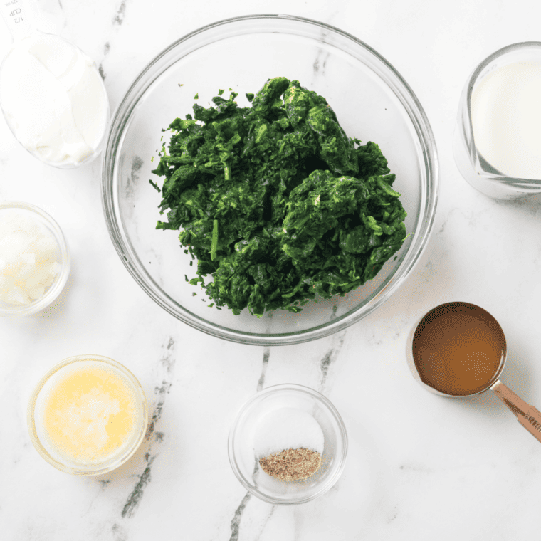 Ingredients needed for Easy Creamed Spinach on kitchen table.