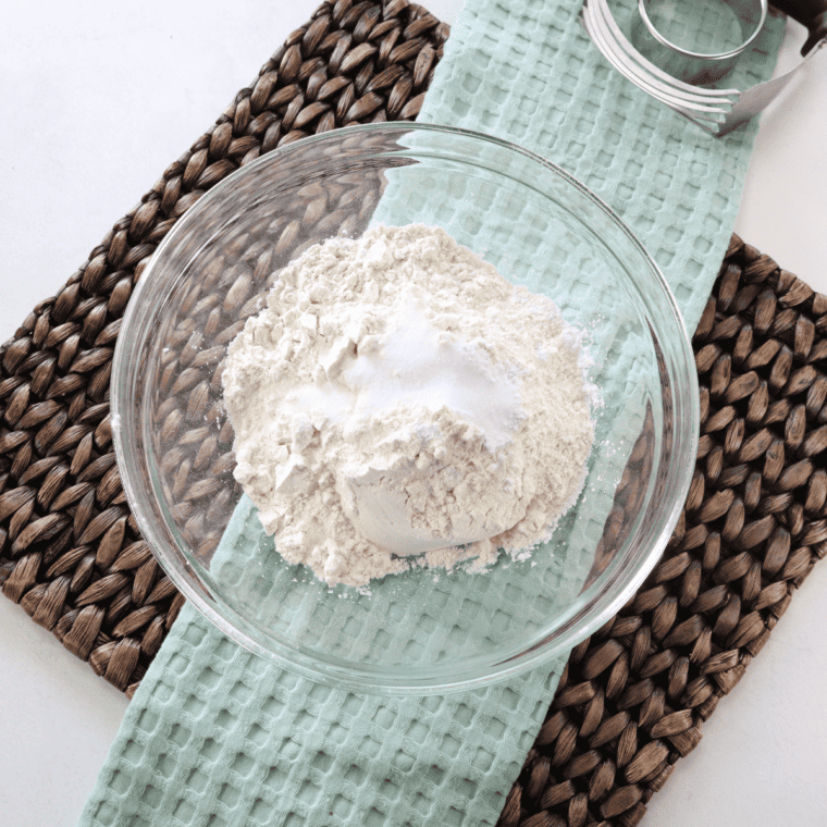 Mixing self-rising flour, baking soda, sugar, oil, buttermilk, and activated yeast for Hardee's biscuit dough.