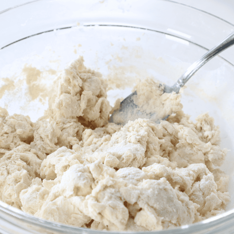 Mixing flour, baking soda, sugar, oil, buttermilk, and yeast for biscuit dough.