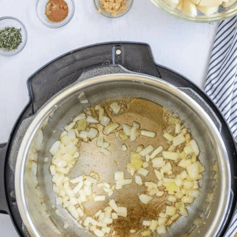 Sauteing diced onion and minced garlic in melted butter.