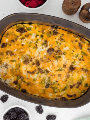 Slow cooker breakfast casserole with eggs, sausage, cheese, and hash browns served in a white dish