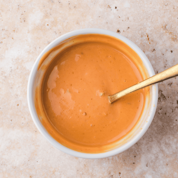 Whisking together Thousand Island dressing, ketchup, Worcestershire sauce, and mustard for Frisco sauce.