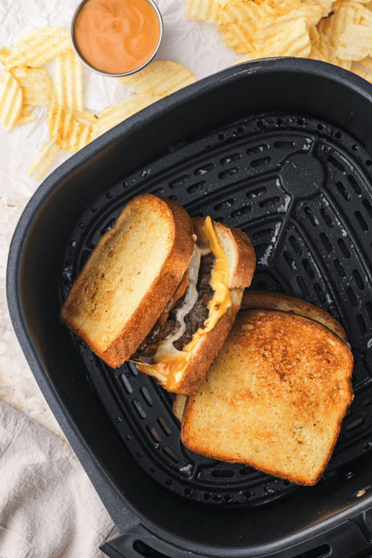 Steak and Shake Frisco Patty Melts with beef, Swiss, American cheese, and Frisco sauce on toasted sourdough.