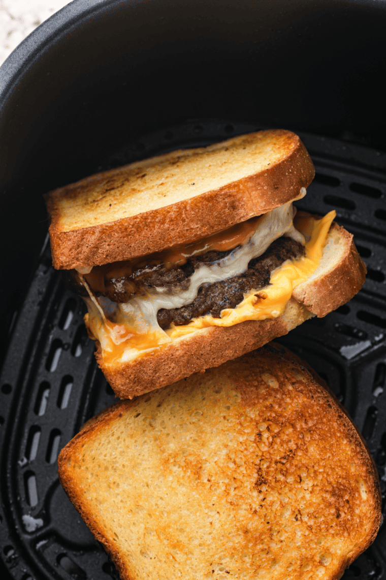 Homemade Steak and Shake Frisco Patty Melts with beef, melted cheese, Frisco sauce, and toasted sourdough bread.