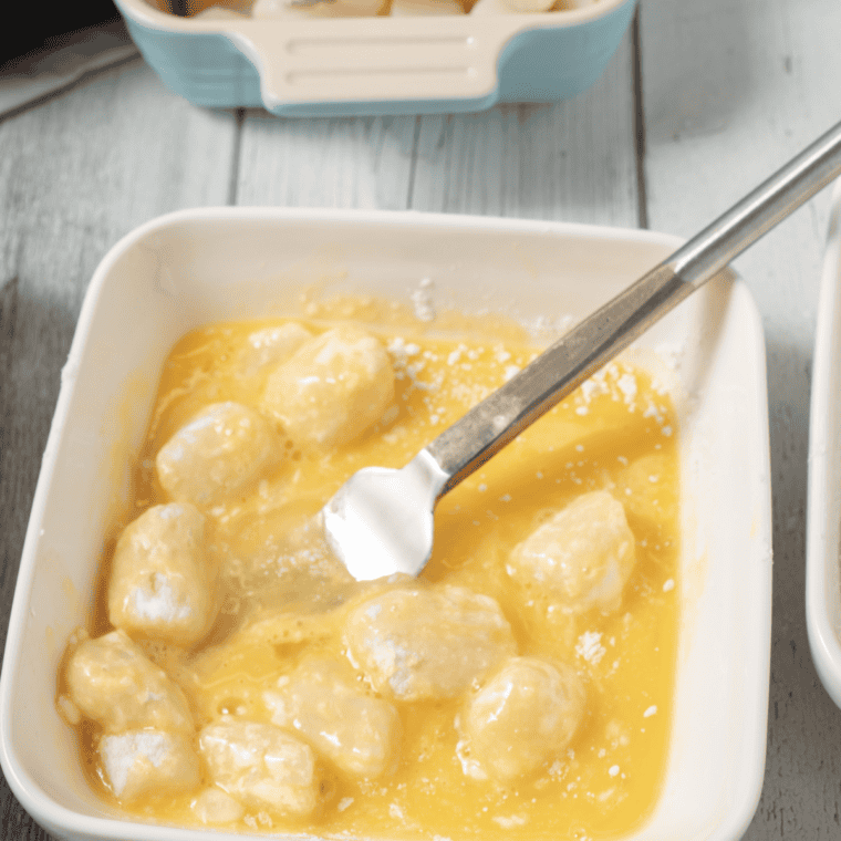 Bay scallops being coated in flour, dipped in egg, and tossed in seasoned panko mixture for breading.