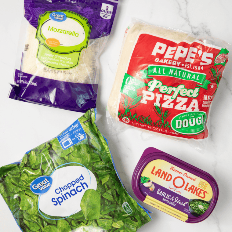 Ingredients needed for Air Fryer Flaky Spinach Garlic Rounds on kitchen table.