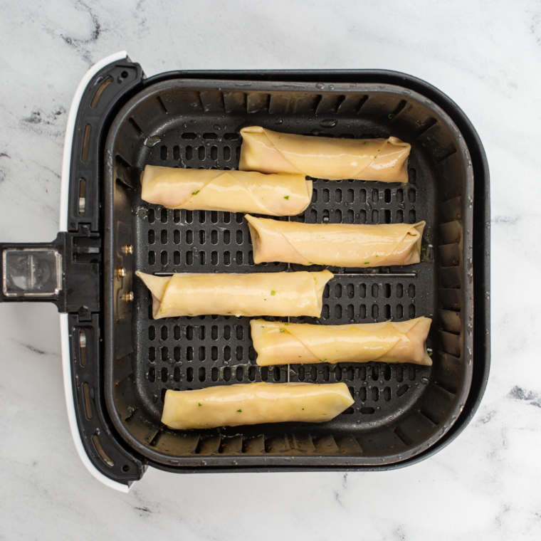 Spray the wontons lightly with olive oil, arrange them in a single layer in the air fryer basket, and cook at 375°F for 6-8 minutes until golden and crispy.