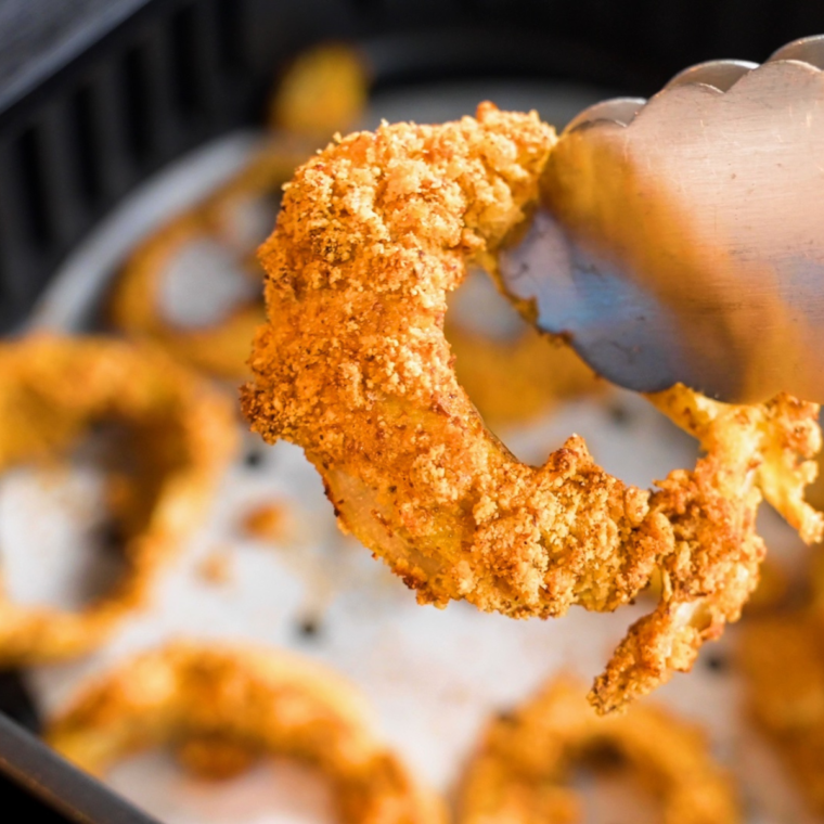 Golden, crispy Air Fryer keto onion rings with a crunchy almond flour and pork rind breading, served with dipping sauce.