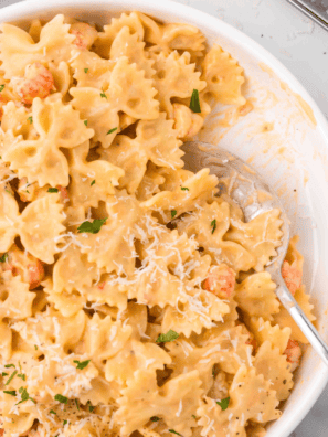 A bowl of creamy Air Fryer Lobster Bisque Pasta topped with tender lobster pieces and garnished with fresh herbs.