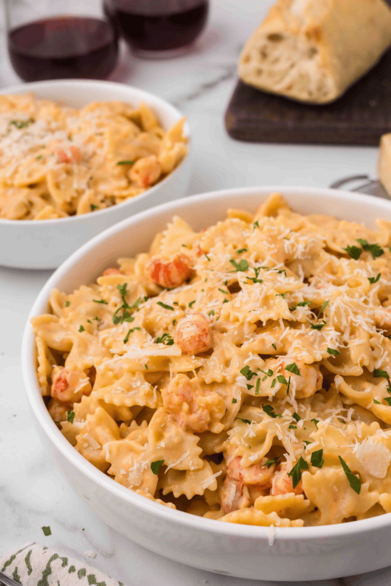 Creamy Air Fryer Lobster Bisque Pasta topped with lobster tails and fresh parsley, served in a bowl.