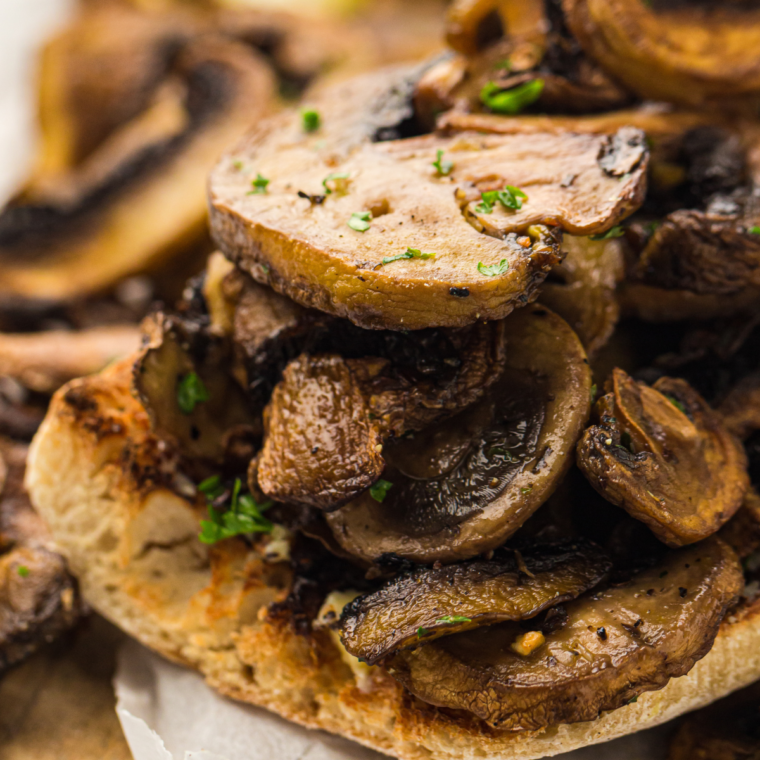 Air fryer mushroom toast topped with sautéed mushrooms and fresh herbs on golden crispy bread.