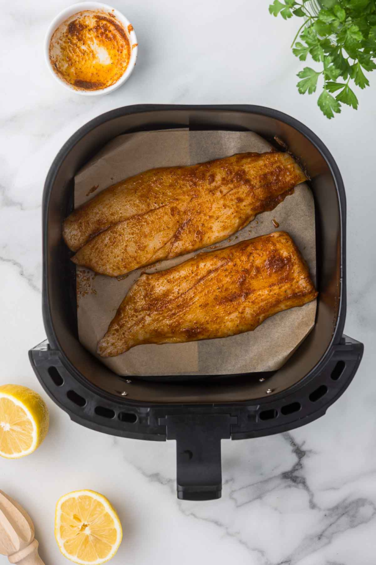 Place seasoned orange roughby into the air fryer basket, leaving space in between the fish fillets.