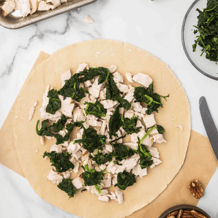 Place the squeezed spinach on top of the chicken.