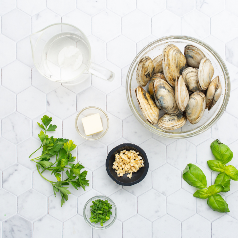 Ingredients needed for Air Fryer Steamed Clams on kitchen table.