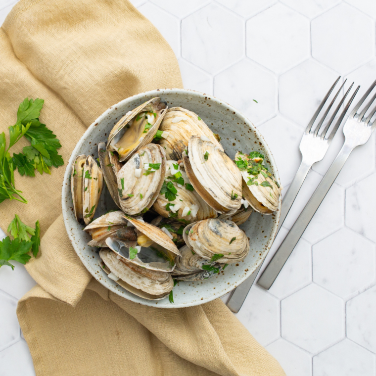Air Fryer Steamed Clams in a garlic butter herb sauce, served in a bowl with fresh parsley.