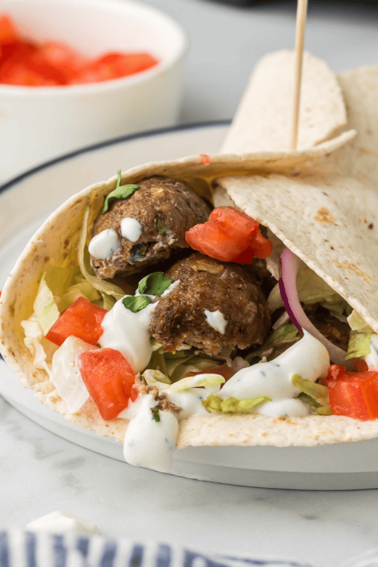Air Fryer Turkish Lamb Wrap filled with seasoned lamb, fresh vegetables, and yogurt sauce wrapped in a soft flatbread.