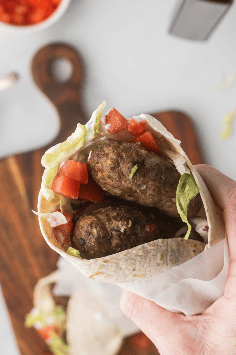 Turkish lamb wrap made in the air fryer, filled with spiced ground lamb, crisp vegetables, and creamy yogurt sauce in a soft flatbread.