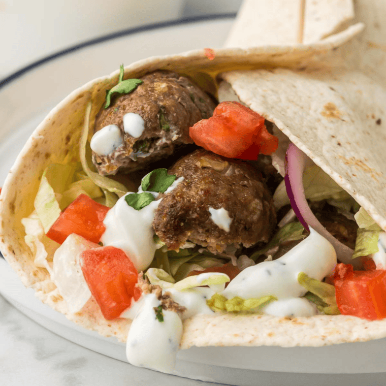 Air Fryer Turkish Lamb Wrap filled with spiced lamb, tomatoes, cucumbers, and yogurt sauce wrapped in soft flatbread.