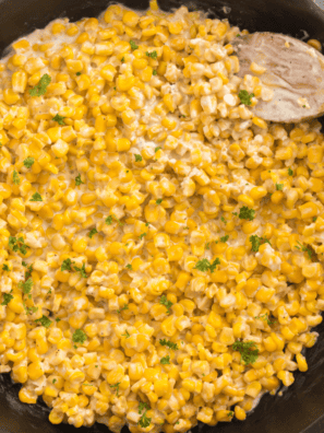 Golden, charred corn cooked in a cast iron skillet with butter and seasonings.