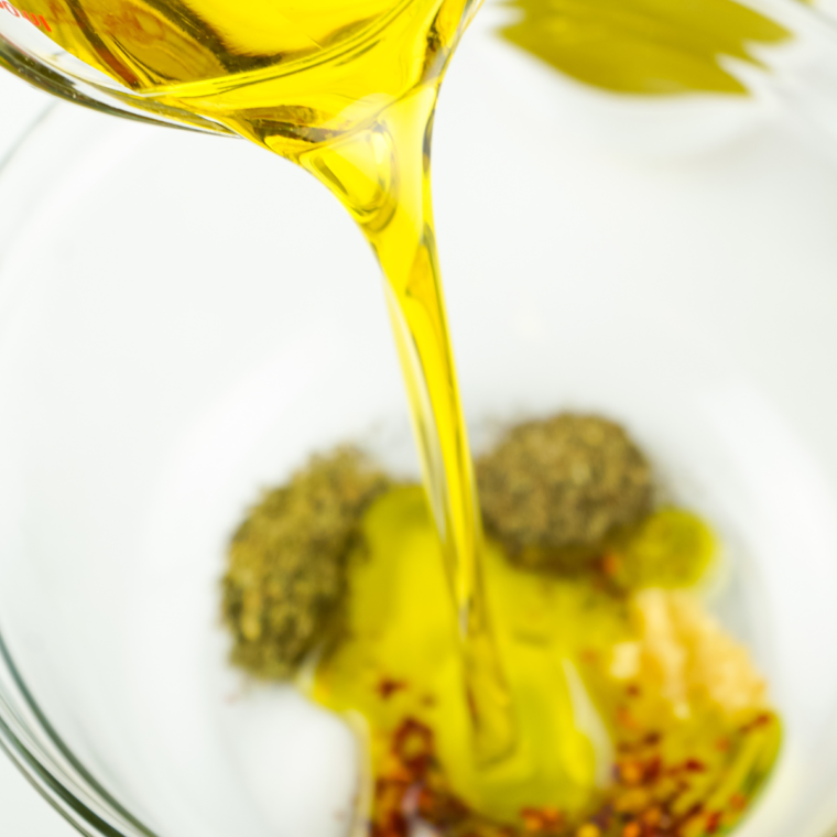 Slowly pour in the olive oil, in with the seasonings.