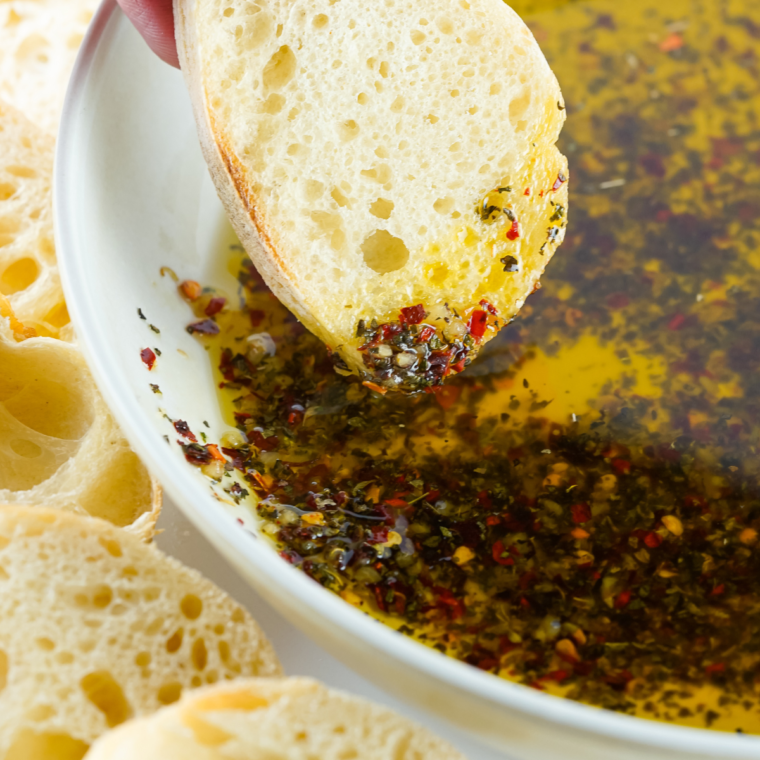 Delicious homemade bread dipping oil served with fresh bread slices.