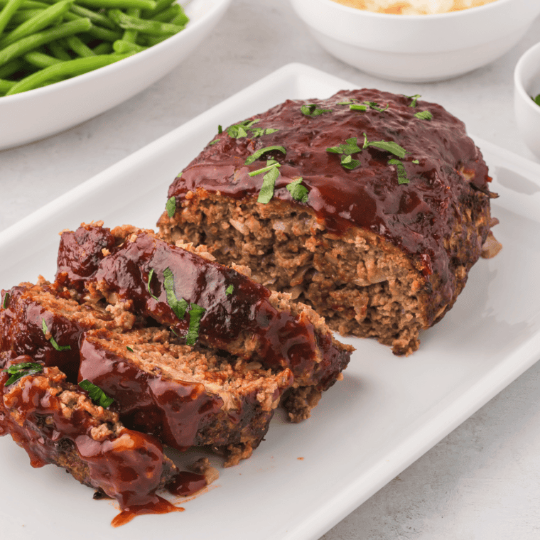 Delicious homemade Copycat Cracker Barrel Meatloaf served with mashed potatoes and sides.