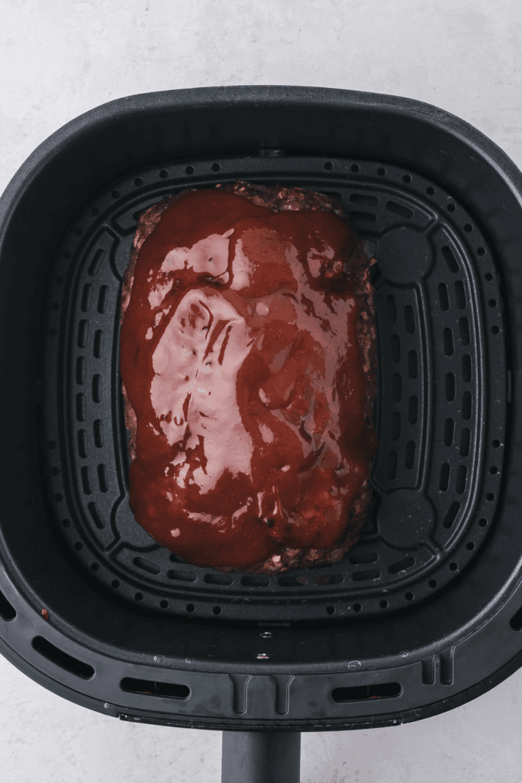 Cooking meatloaf in the air fryer at 350°F until it reaches 160°F internal temperature.