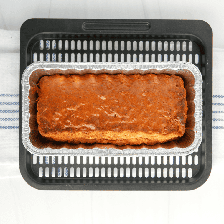 Cooked carrot cake on air fryer tray.