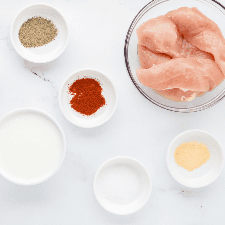 Ingredients needed for Cracker Barrel Fried Chicken Tenders on kitchen table.