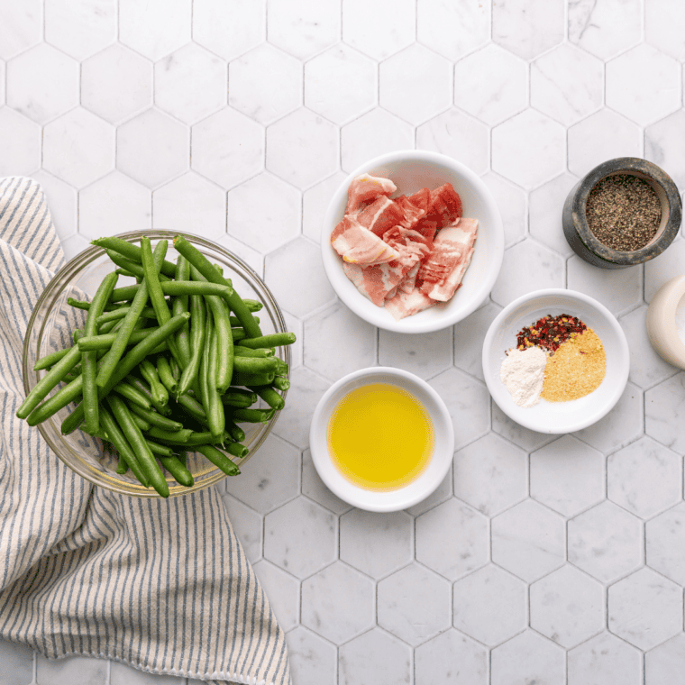 Ingredients needed for Cracker Barrel Green Beans Recipe on kitchen table.