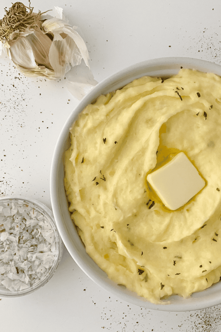 Cracker Barrel Mashed Potatoes served in a bowl with melted butter and herbs on top