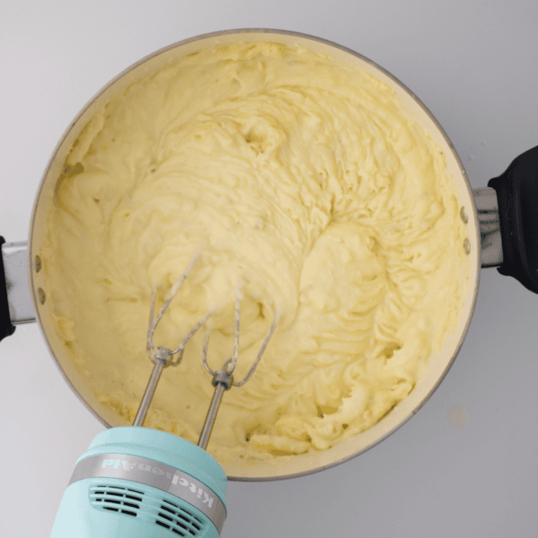 Using a hand mixer to make smoothy Cracker Barrel Mashed Potatoes.