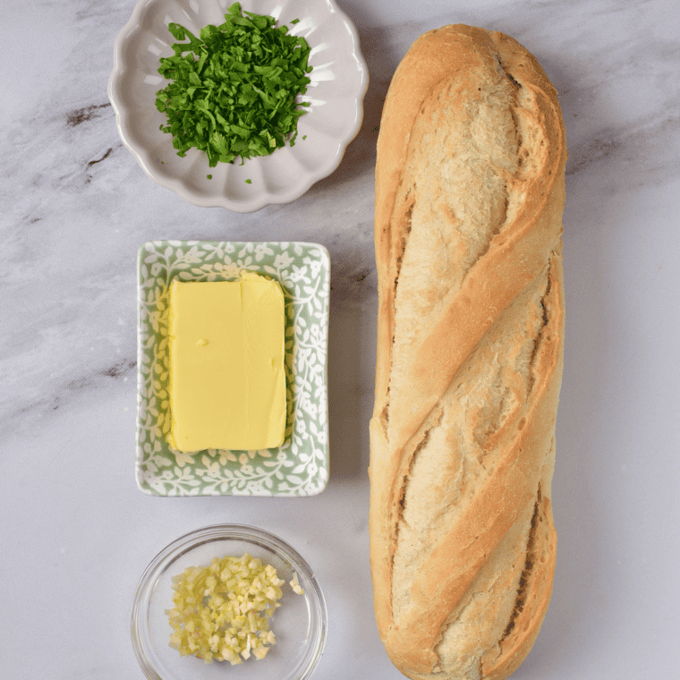 Ingredients needed for Easy Garlic Bread Spread Recipe on kitchen table.