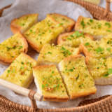 Easy Garlic Bread Spread Recipe made with butter, garlic, and herbs, perfect for spreading on fresh bread before baking.