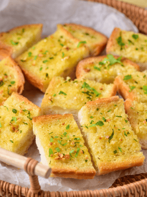Easy Garlic Bread Spread Recipe made with butter, garlic, and herbs, perfect for spreading on fresh bread before baking.