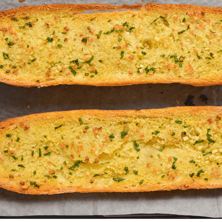 Easy Garlic Bread Spread Recipe with garlic, butter, and herbs spread on bread, ready to bake.
