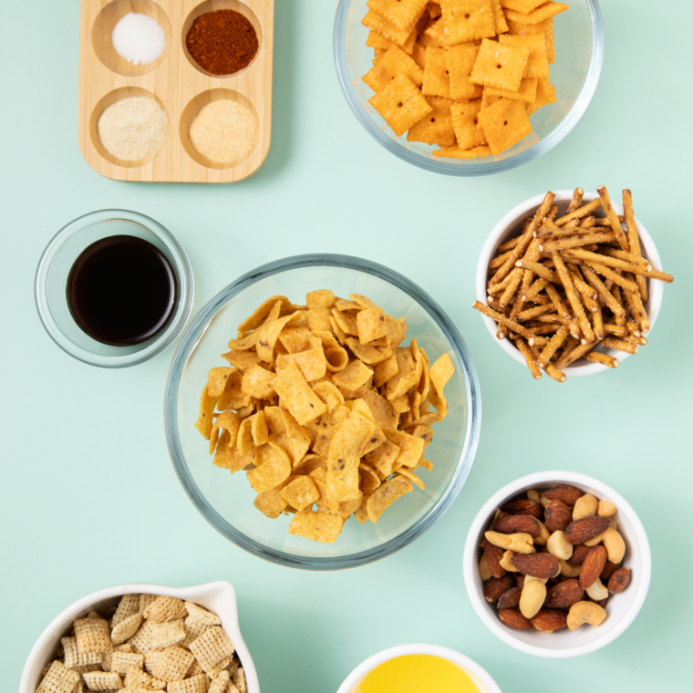 Ingredients needed for Frito Snack Mix on kitchen table.