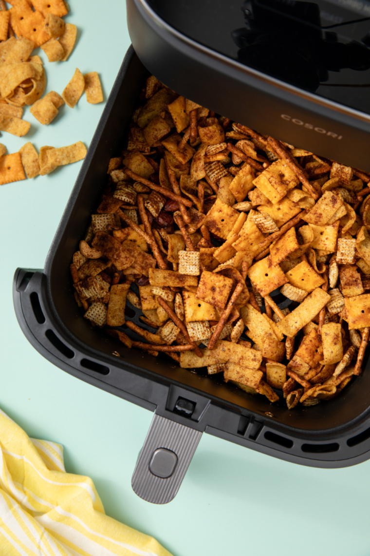 Bowl of homemade Frito Snack Mix with crunchy Fritos, pretzels, nuts, and savory seasoning