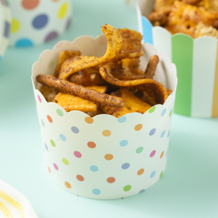 Bowl of homemade Frito Snack Mix with pretzels, nuts, and seasoned corn chips
