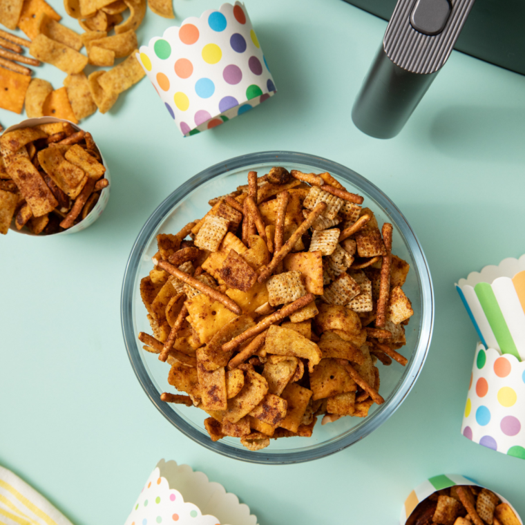 Close-up of homemade Frito Snack Mix with Fritos, pretzels, nuts, and seasonings
