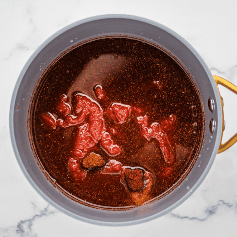 Mixing tomato paste, water, vinegar, brown sugar, and honey in a saucepan over medium heat until smooth.

