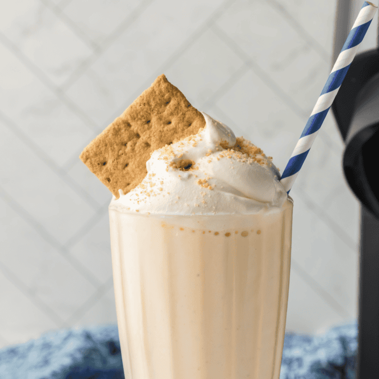 Thick and creamy Ninja Creami copycat Sonic Cheesecake Milkshake topped with whipped cream and a cherry.