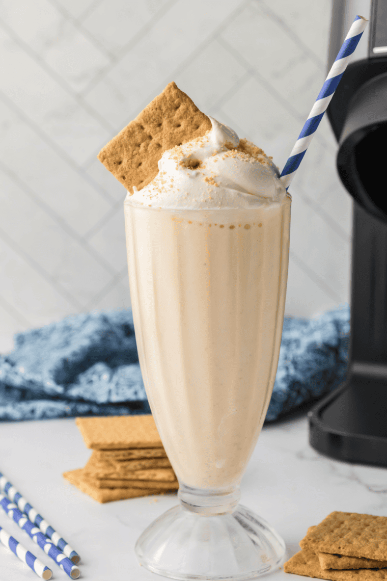 Homemade Sonic-style cheesecake milkshake made in a Ninja Creami, topped with whipped cream and a cherry.