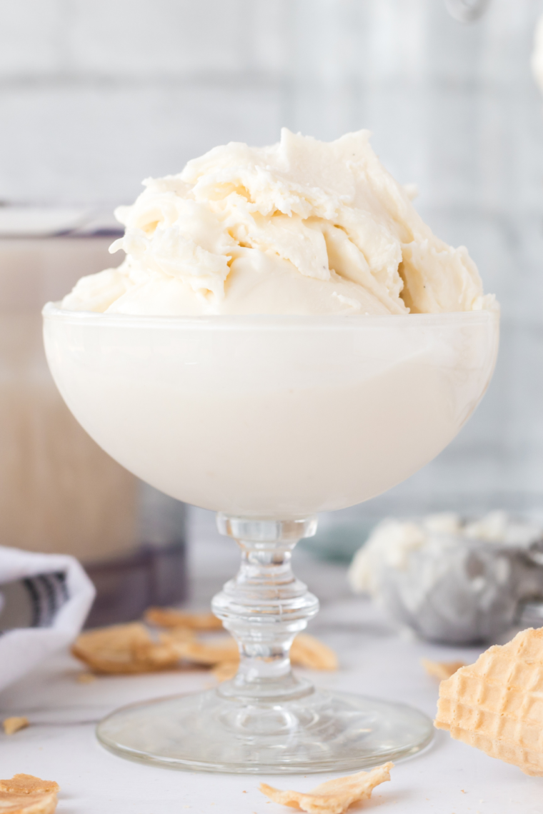 Creamy scoop of Ninja Creami dairy-free vanilla ice cream in a bowl with a spoon.