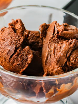 Scoop of Ninja Creami frozen hot chocolate in a bowl, topped with whipped cream and chocolate shavings.