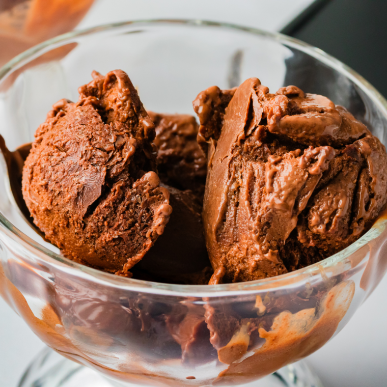 Scoop of Ninja Creami frozen hot chocolate in a bowl, topped with whipped cream and chocolate shavings.