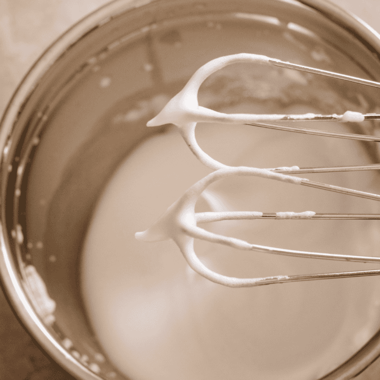 Separating egg yolks from whites and whipping egg whites to stiff peaks for pancake batter