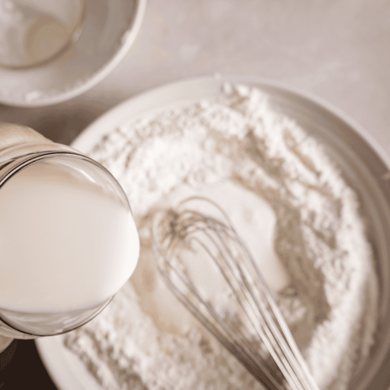 Mixing dry ingredients, adding wet ingredients, folding in egg whites, and resting pancake batter